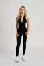 Sleek black Day to Night Jumpsuit with front zipper for adjustable coverage.