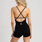 Breathable women’s romper with crisscross back and flattering fit.